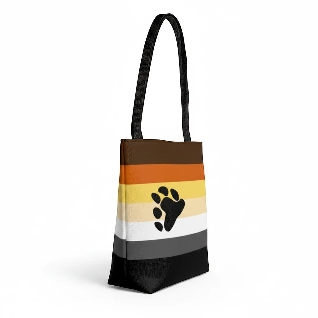 65mcmlxv tote bag with bear pride flag print and black paw print graphic. Made of polyester with black handles.