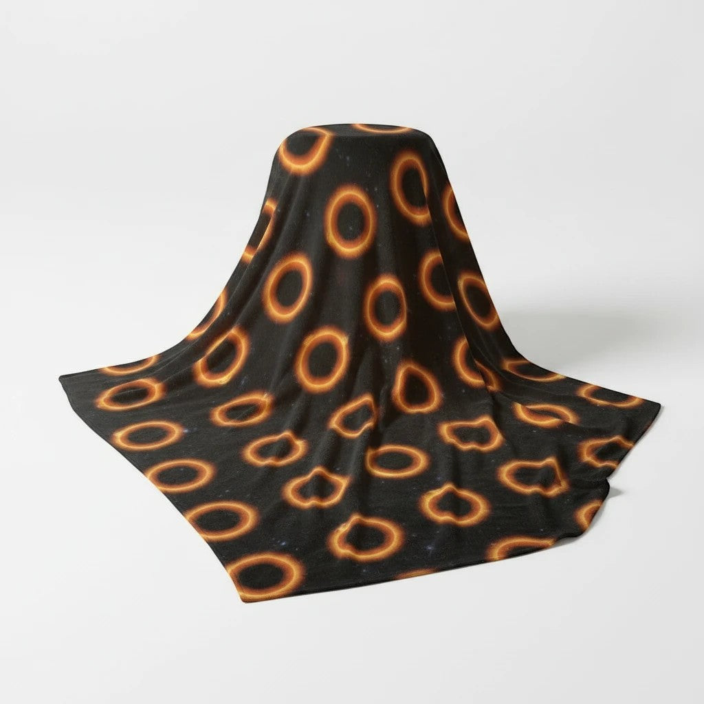 65mcmlxv black polar fleece blanket with solar eclipse polka dot pattern. 130 x 175 cm.