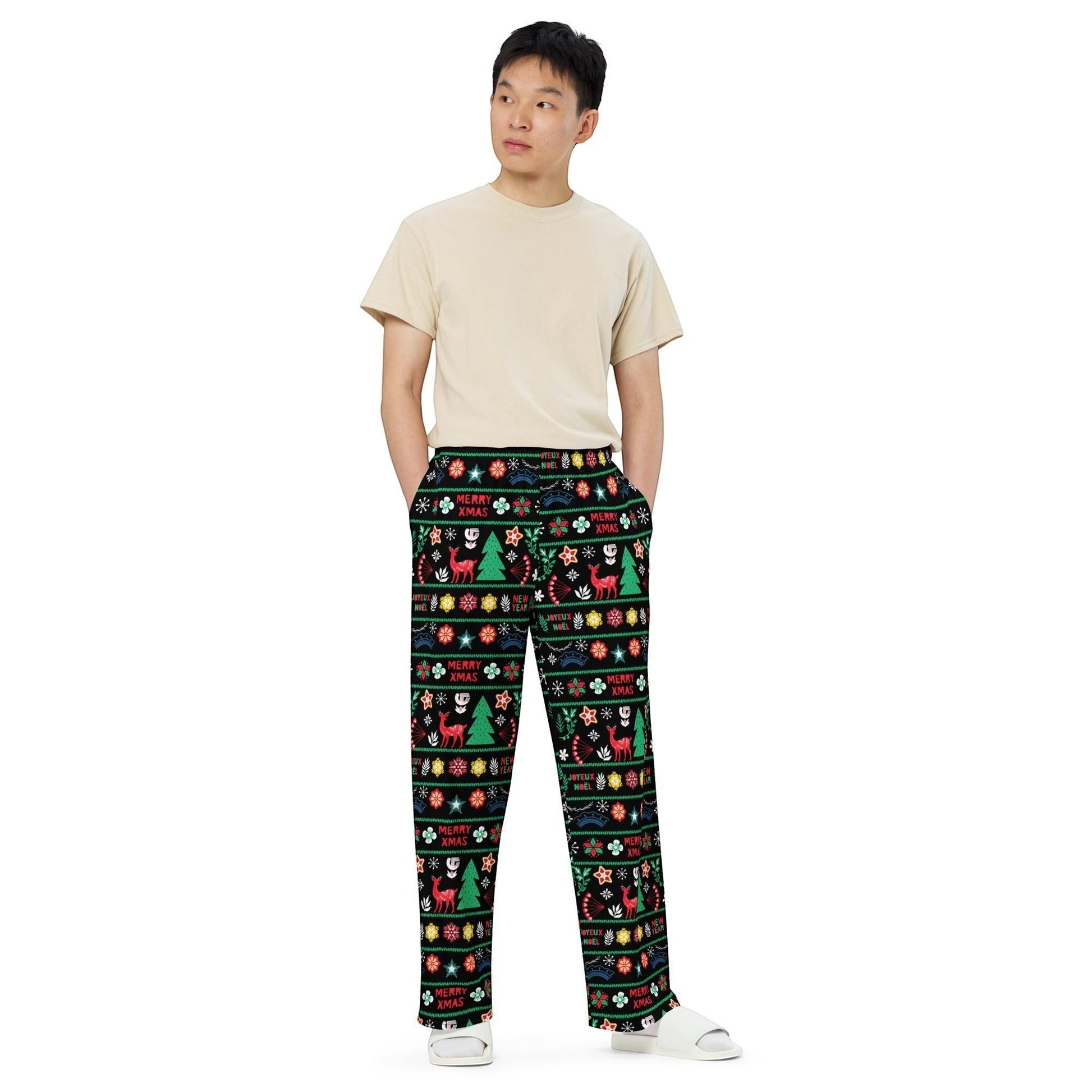 65mcmlxv unisex wide-leg lounge pants with a black background and a festive Scandinavian Nordic Christmas fairisle print featuring reindeer, Christmas trees, and snowflakes.