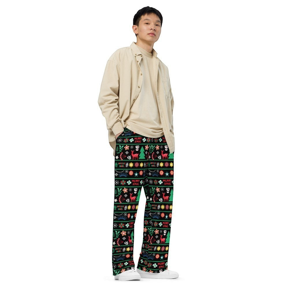 65mcmlxv unisex wide-leg lounge pants with a black background and a colorful Scandinavian Nordic Christmas fairisle print featuring reindeer, trees, and snowflakes.