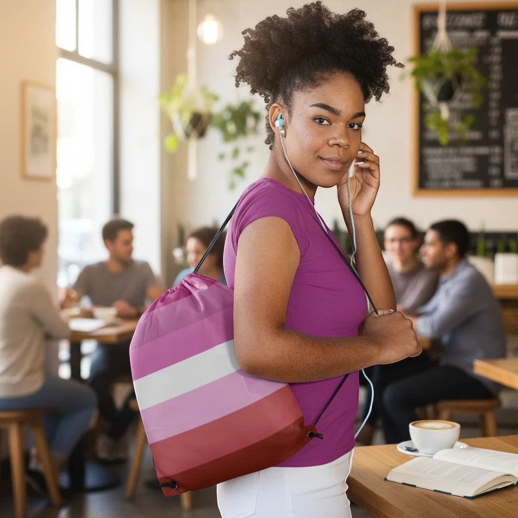 65mcmlxv Lesbian Pride flag print drawstring bag made of spun polyester with twin cotton handles and drawstring closure.