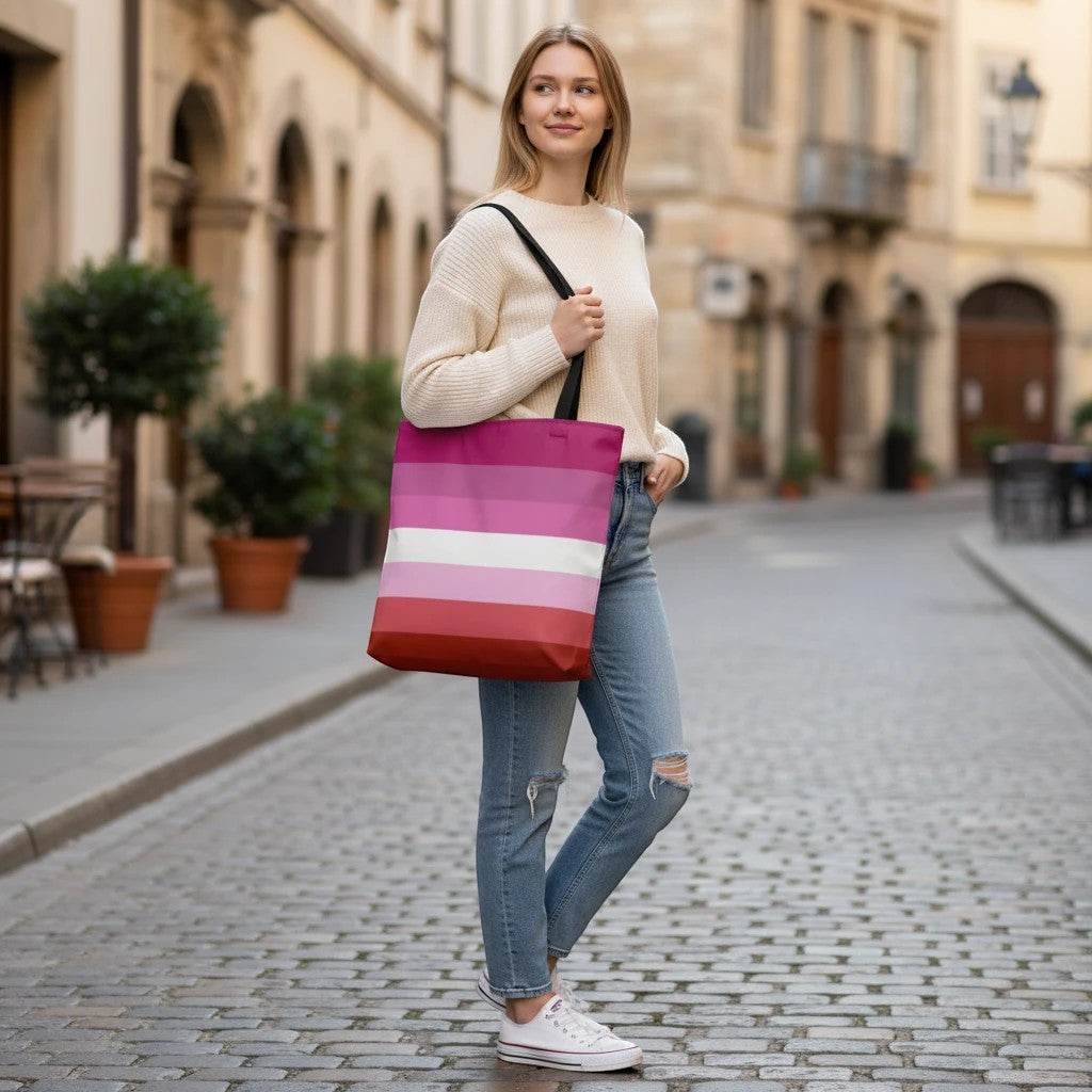 65 MCMLXV large tote bag with lesbian pride flag print in pink, white, and red stripes. Black handles and lining.