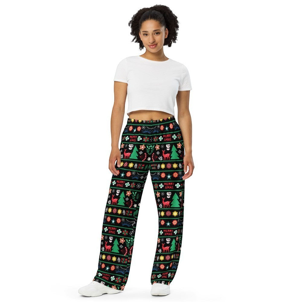 65mcmlxv unisex wide-leg lounge pants with black fabric, featuring a Nordic Christmas Fairisle print with trees, deer, snowflakes, and text.