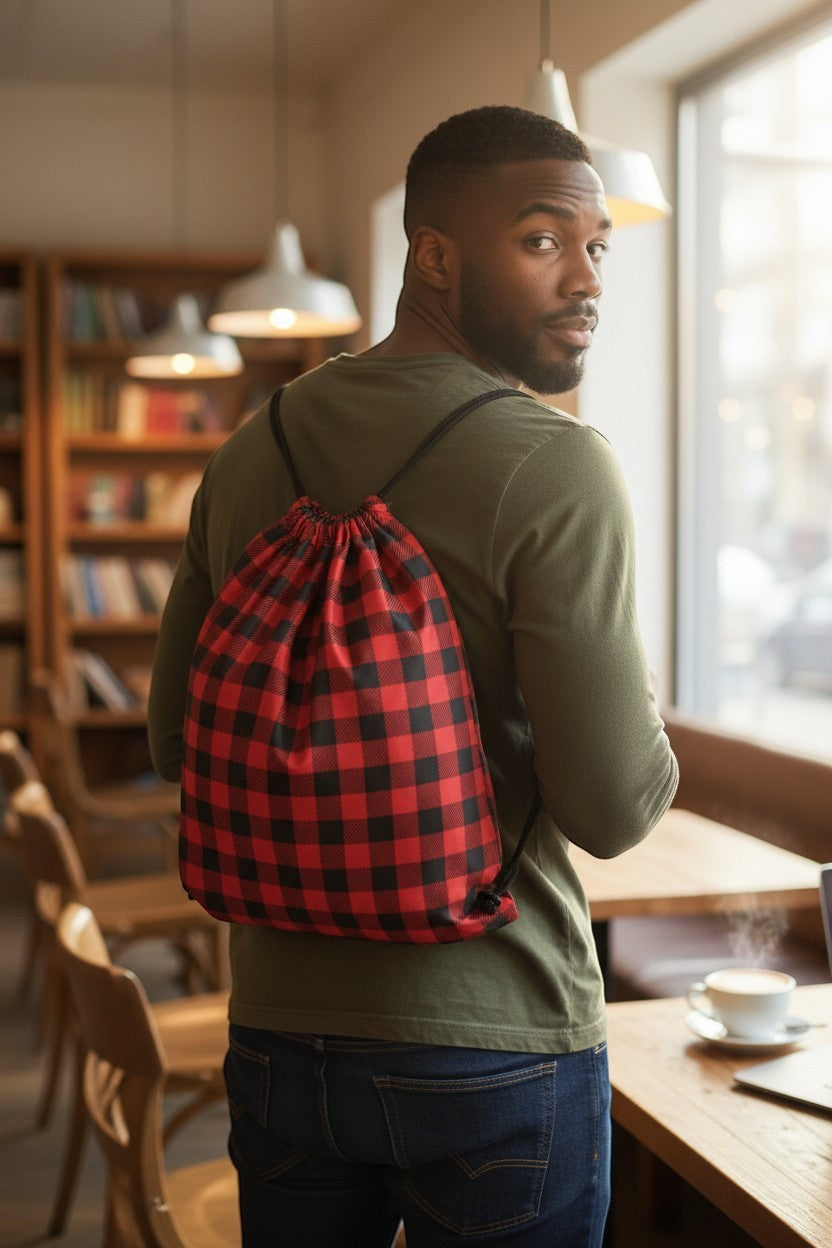 65 MCMLXV red and black buffalo plaid print linen drawstring sack bag worn by a man.