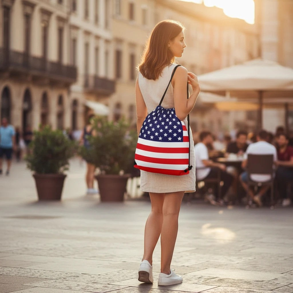 65mcmlxv Americana USA flag print drawstring bag made of spun polyester with a drawstring closure and shoulder straps.